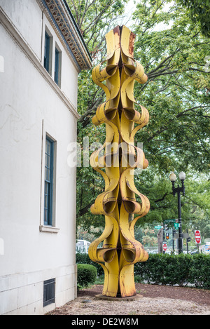 WASHINGTON DC, USA - A yellow metal sculpture outside the main entrance of the Art Museum of the Americas, housed in a 1912 Spanish colonial building that is part of the Organization of American States complex in Washington DC's Foggy Bottom district. The Art Museum of the Americas in Washington DC showcases an impressive collection of modern and contemporary art from Latin America and the Caribbean. As part of the Organization of American States, the museum plays a significant role in promoting cultural diplomacy and dialogue across the Americas. Stock Photo