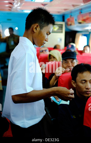 collecting tickets in one of the lounges aboard express fast boat the bahari near karimunjawa island from jepara java indonesia Stock Photo