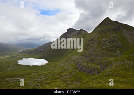 The Scottish mountain Spidean Coinich (a Corbett) on Quinag with Lochan Bealach Cornaidh and an unnamed top seen from the north. Stock Photo