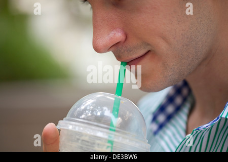 Man drinking an iced coffee Stock Photo