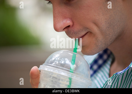 Man drinking an iced coffee Stock Photo