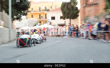Men take part in the quirky annual Pedal Car Grand Prix. Vigevano, Pavia. Italy Stock Photo