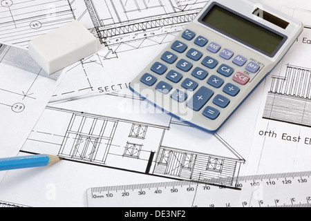 Calculator,rubber,pencil and ruler on architectural drawings. Plans are copyright-free Stock Photo