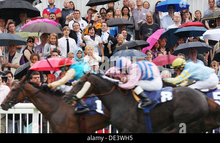 Iffezheim, Germany, people follow a horse race in the rain Stock Photo