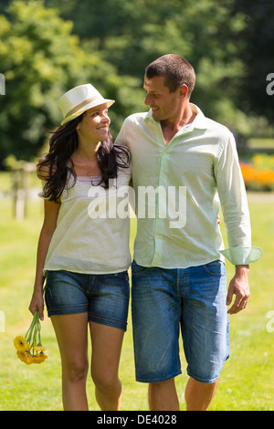 Couple in love walking outdoors and looking at each other Stock Photo