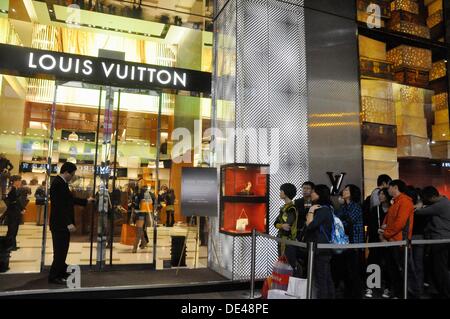 People stand in line as they flock to the Louis Vuitton store to News  Photo - Getty Images