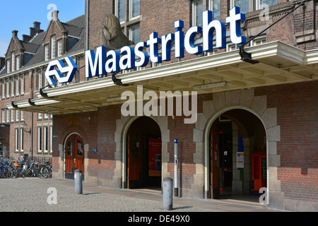 Maastricht City railway train station building close up main entrance & logo sign nearby cyclists bike parking facility Limburg Netherlands Europe EU Stock Photo