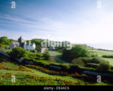 Penmon, Anglesey: wide landscape view of priory, church, dovecote & Deer Park wall, with Flagstaff Quarry, Conwy Bay & Great Orme's Head to rear. Stock Photo