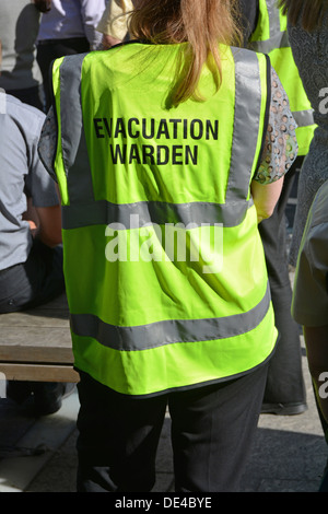 Close up of high visibility vest worn by evacuation warden during practice mass office workforce fire drill Stock Photo