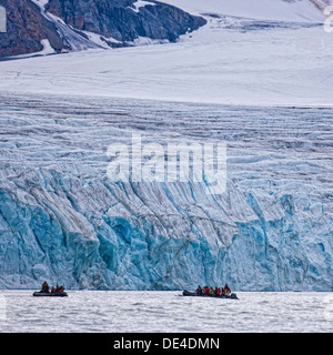 People on Zodiacs exploring by The 14th of July Glacier, Spitsbergen Island, Svalbard, Norway Stock Photo