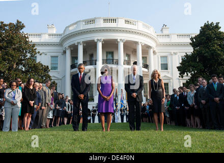 Washington DC, USA. 11th Sep, 2013. United States President Barack Obama (L), First Lady Michelle Obama, Vice President Joe Biden, Dr. Jill Biden and White House staff observe a moment of silence for the 12 anniversary of the 9/11 terrorist attacks, at the White House on September 11, 2013 in Washington, D.C. Credit: Kevin Dietsch / Pool via CNP Credit:  dpa picture alliance/Alamy Live News Stock Photo