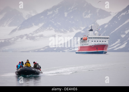 Tourist on Zodiacs heading toward Smeerenburg with cruise ship, Spitsbergen, Svalbard, Norway Stock Photo