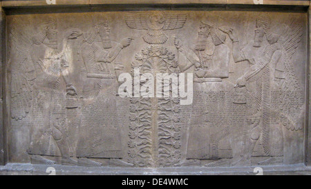 Relief with two figures of Ashurnasirpal, winged mythological beings and the god Ashur, before the Tree of Life, 885-860 BC. Artist: Assyrian Art Stock Photo