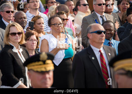 Arlington, Virginia, USA. 11th Sep, 2013. Family members of those killed during the 9/11 terrorist attack on the Pentagon stand in memory of those who lost their lives during the Pentagon Observance Ceremony September 11, 2013 in Arlington, VA. Credit:  Planetpix/Alamy Live News Stock Photo