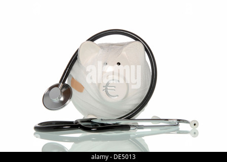 Bandaged piggy bank with a stethoscope, symbolic image for health insurance companies in financial distress Stock Photo