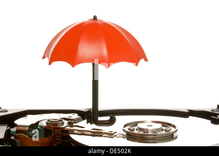 Small umbrella on a hard drive, symbolic image for data protection Stock Photo