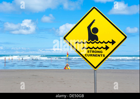 Warning sign 'strong currents', on a beach, Muriwai Beach, West Coast, Auckland, Auckland Region, New Zealand Stock Photo