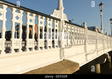 White painted wrought iron railings handrail on Tonbridge bridge potential roosting place for pigeons but for deterrent spikes Stock Photo