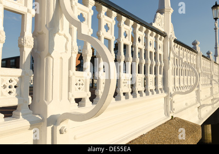 White painted wrought iron railings handrail on Tonbridge bridge potential roosting place for pigeons but for deterrent spikes Stock Photo