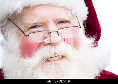 Close up face shot of Santa Claus smiling and wearing glasses Stock Photo