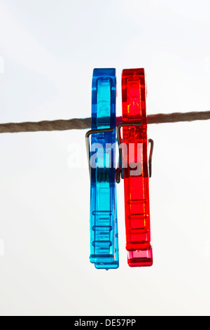 Red and blue pegs on a clothesline Stock Photo