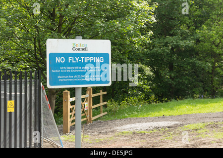 Bolton Council No Fly Tipping sign on open ground near Bradford Road , Bolton, citing the UK Environmental Protection Act 1990. Stock Photo