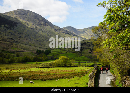 Cyclists in Little Langdale in the English Lake District with the Coniston Fells behind Stock Photo