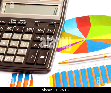 Business picture: calculator and financial graphs Stock Photo