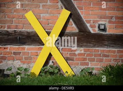 Gartow, Germany, yellow X on a wall, a symbol of resistance against a nuclear waste storage site Stock Photo