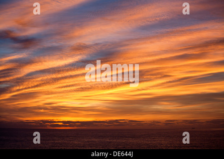 A magnificent flaming autumn sunset over the Cornish Coast at Pendeen Stock Photo