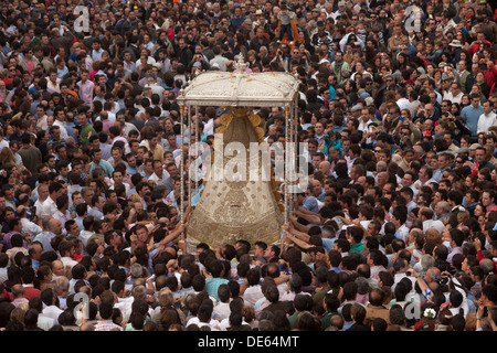 The image of Our Lady of El Rocio is carried by a crow in a procession in El Rocio village, Andalusia, Spain Stock Photo