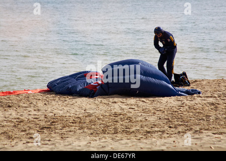 Parachutist landed on the beach as part of Bournemouth Air Festival, Bournemouth, Dorset UK in September Stock Photo