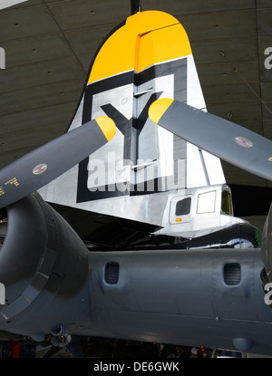 BOEING B-29 FIN AND REAR GUN TURRET OVER THE WING OF A BOEING B-17 FLYING FORTRESS IN IMPERIAL WAR MUSEUM.  DUXFORD.  ENGLAND. Stock Photo