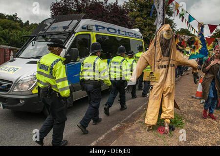 Balcombe,West Sussex, UK. 12th Sept, 2013.Police regroup after lining the road to escort lorry away from Cuadrilla site. The anti fracking environmentalists are protesting against test drilling by Cuadrilla on the site in West Sussex that could lead to the controversial fracking process. Credit:  David Burr/Alamy Live News Stock Photo