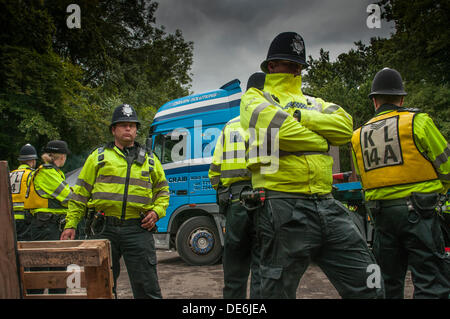 Balcombe,West Sussex, UK. 12th Sept, 2013.Police officers line the roadside as lorry leaves the Cuadrilla site... The anti fracking environmentalists are protesting against test drilling by Cuadrilla on the site in West Sussex that could lead to the controversial fracking process. Credit:  David Burr/Alamy Live News Stock Photo