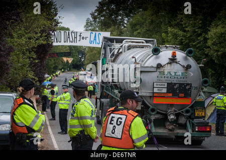 Balcombe,West Sussex, UK. 12th Sept, 2013. Tanker lorry leaves Cuadrilla site through line of Police along the roadside.. The anti fracking environmentalists are protesting against test drilling by Cuadrilla on the site in West Sussex that could lead to the controversial fracking process. Credit:  David Burr/Alamy Live News Stock Photo