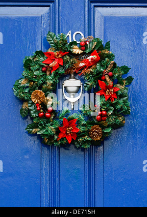 Festive Christmas wreath on door at Christmastime Stock Photo
