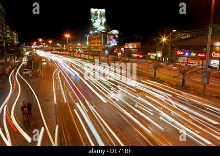 Time exposure at night of traffic headlights streaming along the EDSA highway in Manila, Philippines. Stock Photo