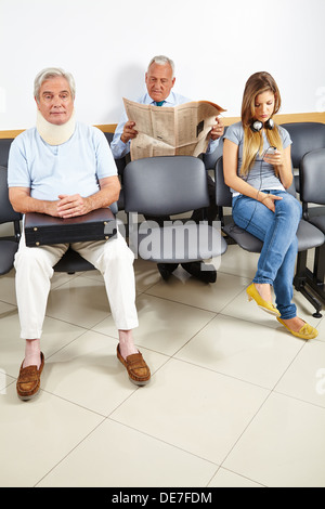 Three patients waiting in a waiting room of a hospital Stock Photo
