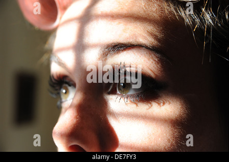 Young beautiful woman 20s with rollers in her hair and wearing eyelash extensions getting ready for a night out Stock Photo