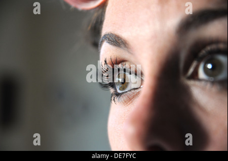 Young beautiful woman 20s with rollers in her hair and wearing eyelash extensions getting ready for a night out Stock Photo