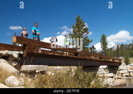 Visitors stop and enjoy the view from the  bridge crossing the Tuolumne river in Tuolumne Meadows in Yosemite National park Stock Photo