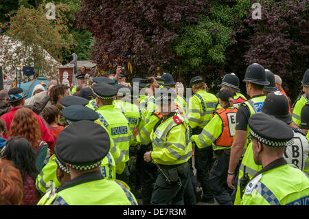 Balcombe, West Sussex, UK. 12th September 2013.  Police Officers hold back protesters as another lorry enters Quadrilla site, it seems at times that Police are now outnumbering protesters... The anti fracking environmentalists are protesting against test drilling by Cuadrilla on the site in West Sussex that could lead to the controversial fracking process. Credit:  David Burr/Alamy Live News Stock Photo