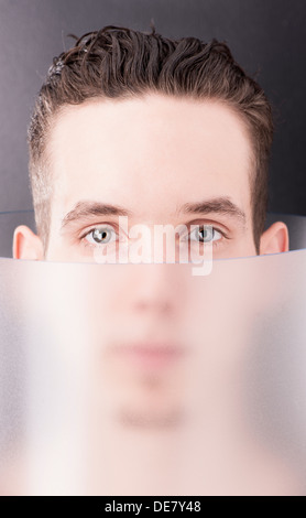 Futuristic portrait of handsome young man inside transparent tube Stock Photo