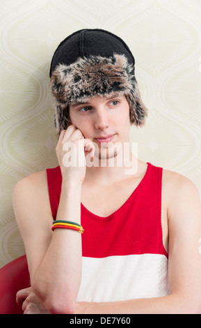 Lifestyle portrait of serious young man with winter hat and tank top Stock Photo