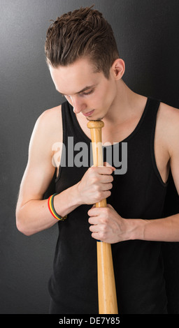 Portrait of focusing young man holding a baseball bat Stock Photo
