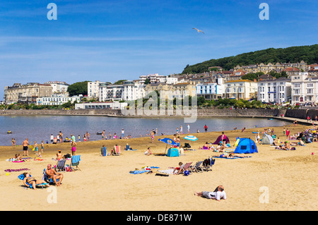 British Seaside beach UK - Marine Lake beach at Weston Super Mare seaside, Somerset with town houses behind in summer Stock Photo