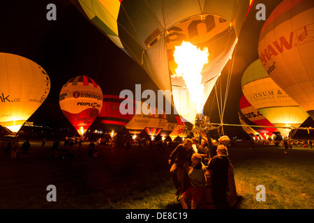 Hot air balloon fiesta bristol in a UK hot air balloon festival, images of balloons, crew setup, burn and take off. night glow Stock Photo