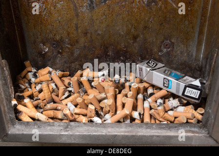 Cigarette ashtray full of stubs. butts.Smoking Damages Your Health. Stock Photo