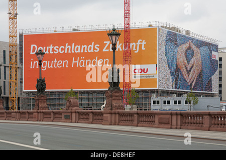 Large poster of the CDU German Chancellor Angela Merkel,  with a typical attitude called the 'Merkel rhombus', Berlin Stock Photo